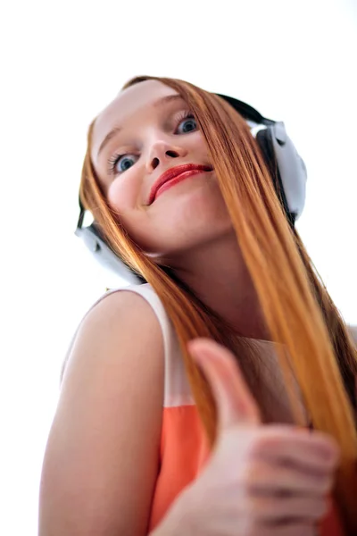 Red headed woman with headphones listening to music — Stock Photo, Image