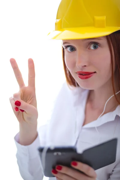 Young beautiful female with yellow helmet showing the v sign — Stock Photo, Image