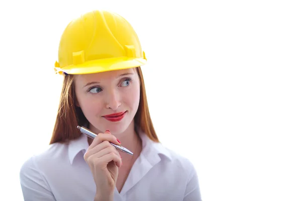 Long haired red headed woman holding a pen and wearing a safety Stock Picture