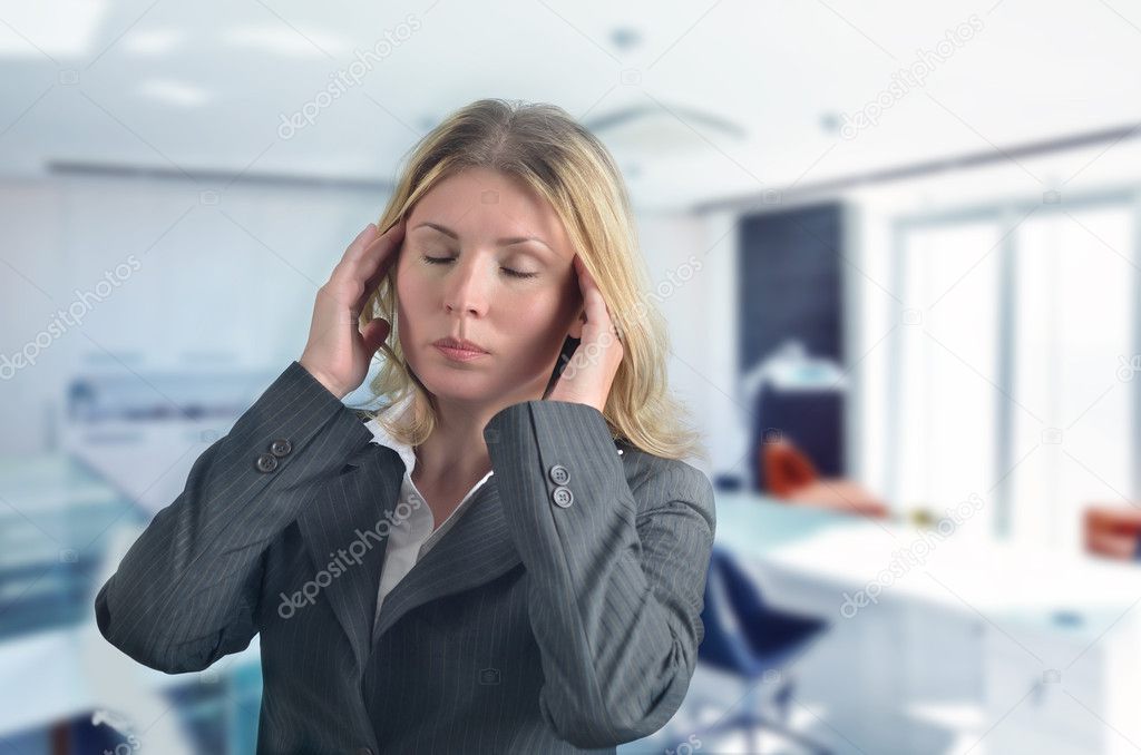 Portrait of young businesswoman having headache pains