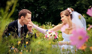 The groom kisses the hand of the bride clipart