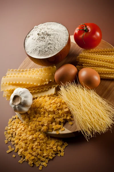 Verscheidenheid van gedroogde pasta en ingrediënten Stockfoto