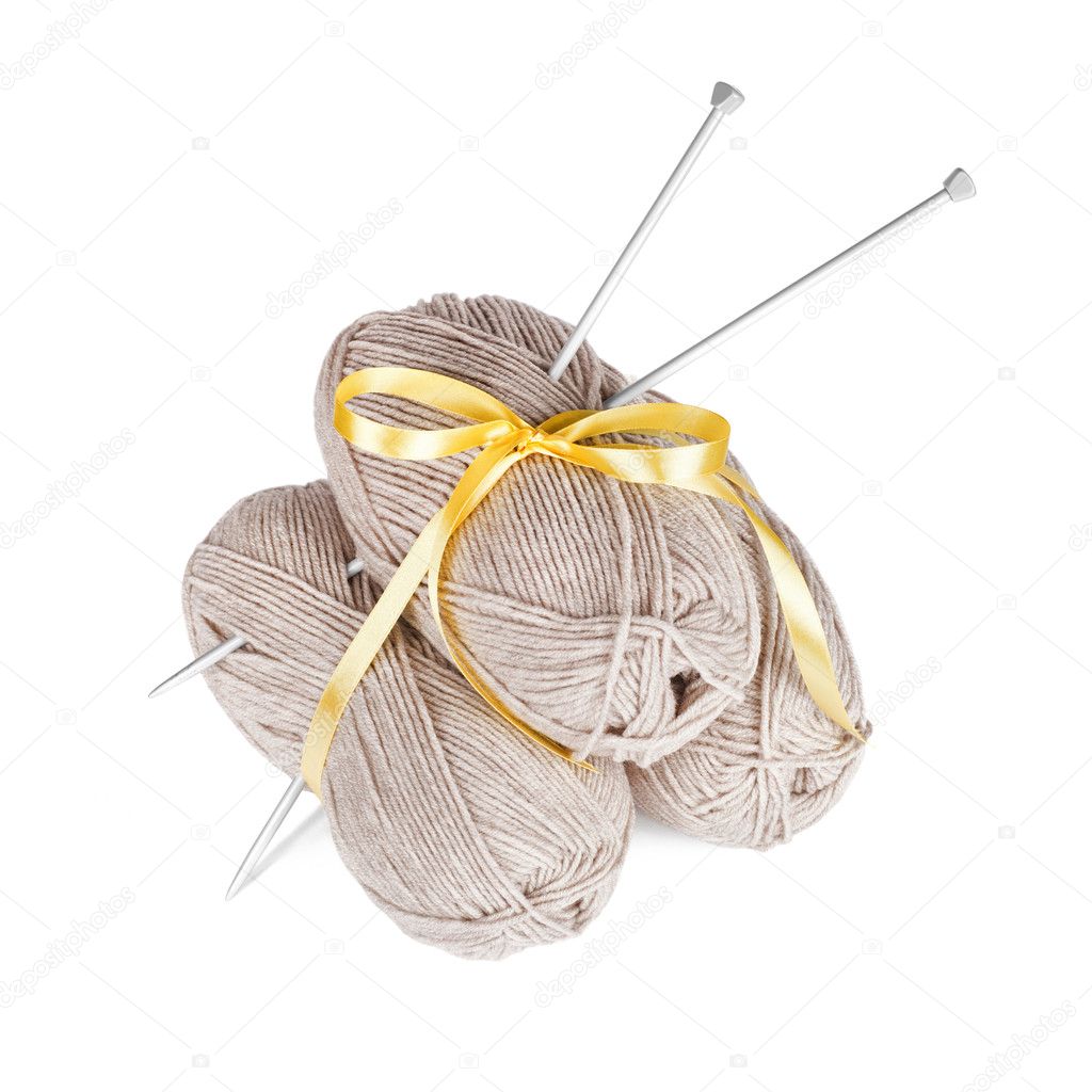 Three balls of wool with knitting needles isolated on white background