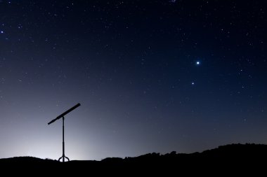 Night shot with a silhouette of a telescope clipart