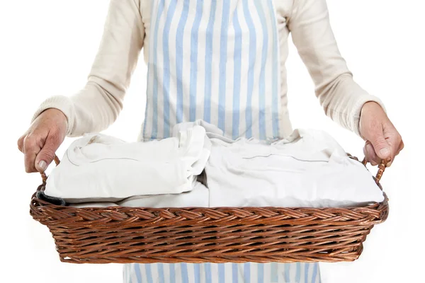 Woman holding a basket of clothes to iron, isolated — Stock Photo, Image