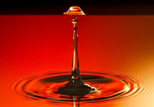 Drop on a drop on a red background — Stock Photo, Image