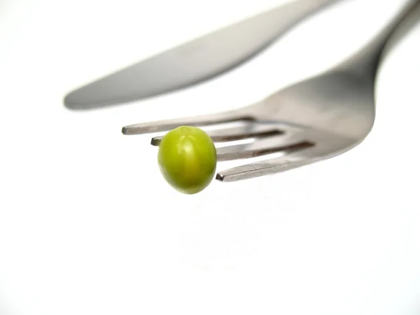 Diet, detail of peas on knife — Stock Photo, Image