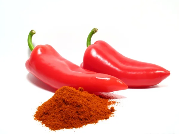 Red paprikas and ground paprika — Stock Photo, Image