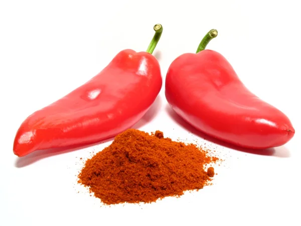 Red paprikas and ground paprika — Stock Photo, Image
