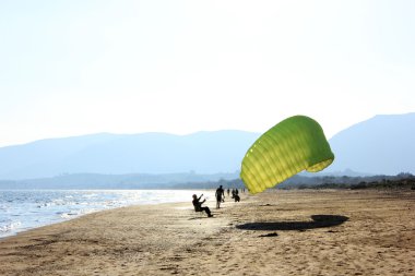 Learning how to do paragliding, Greece clipart