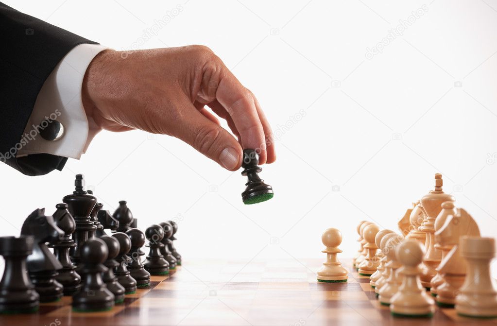 Businessman playing chess game selective focus