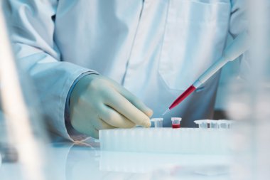 Close up of scientist using pipette in laboratory clipart