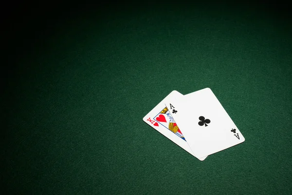 Blackjack hand on green baize table