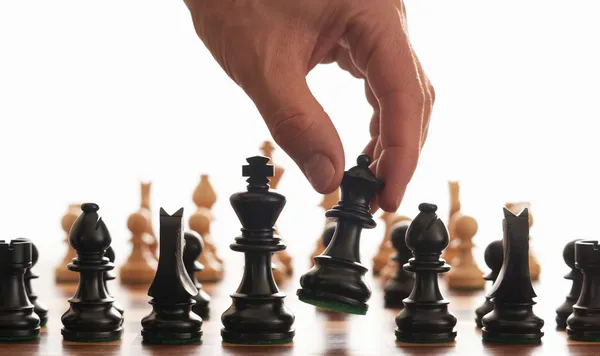 Chess board and hand Royalty Free Stock Photos