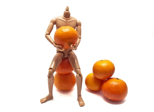 Mandarins and plastic doll — Stock Photo, Image