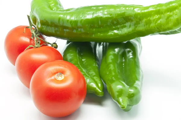 Green peppers with tomatoes — Stock Photo, Image