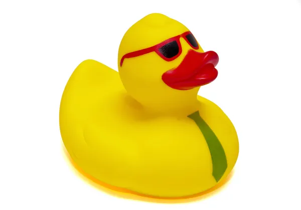 Žlutou gumovou kachnu s brýlemi na bílém pozadí — Stock fotografie