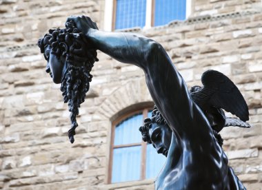Bronze statue of Perseus holding head of Medusa clipart