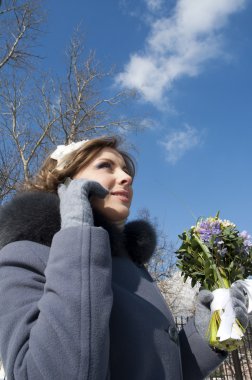 Portrait of a young woman, while she conducted conversations on the phone clipart