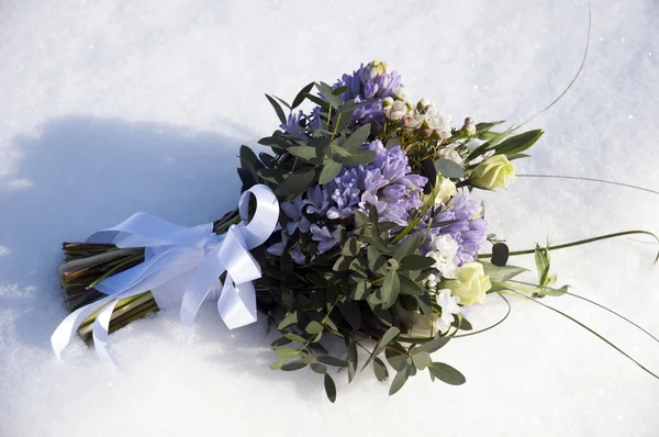 Bouquet of flowers in the snow Royalty Free Stock Images