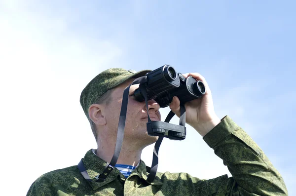 O soldado olha através de binóculos — Fotografia de Stock
