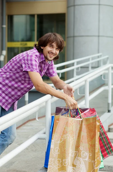 Beautiful young man after shopping. Outdoor shot — Stock Photo, Image