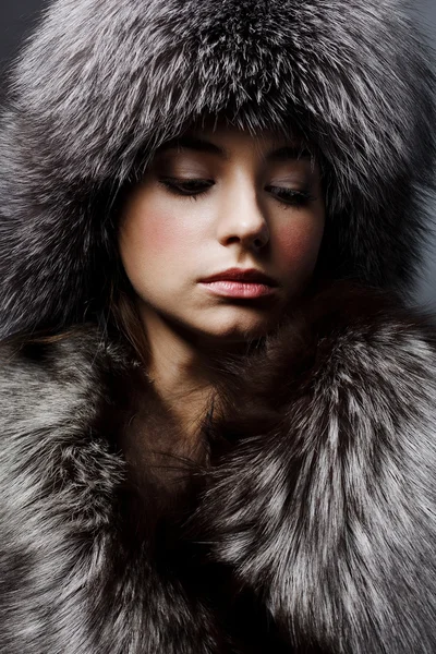 Beautiful young girl in fur clothes. Studio shot — Stock Photo, Image