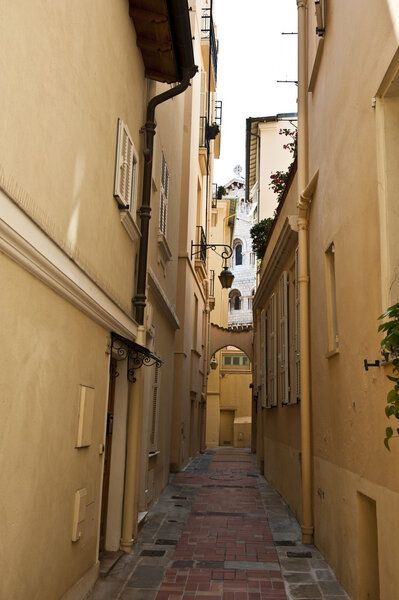A long shot of a private walkway outside of apartment buildings in Monaco.