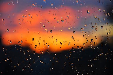 güzel bir gün batımı ile pencere camına Cristal su damlaları