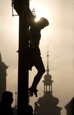 Prague - cross from H. Hilger 1629 on the charles bridge by sunrise - silhouette clipart