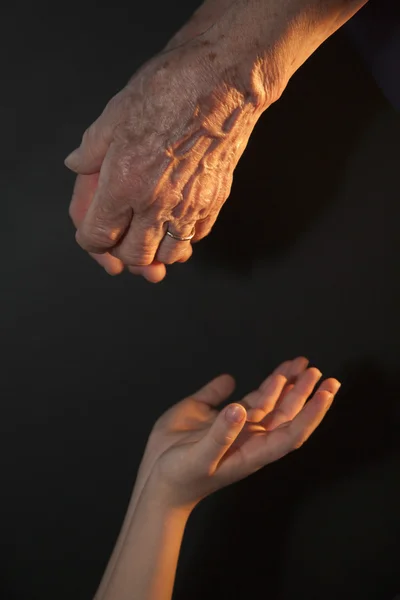Hand av gamla kvinnan och barnet — Stockfoto
