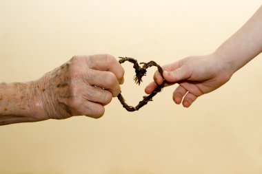 Hands of grandmother and grandchild and heart clipart