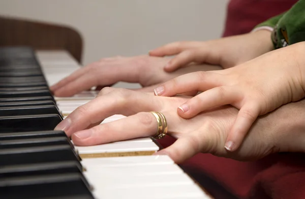 Hands of piano player and the child — Stock Photo, Image