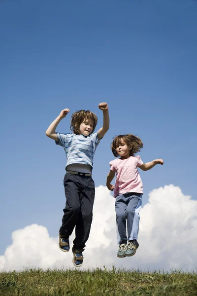Jump of little girls on the meadow — Stock Photo, Image