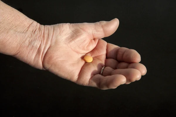 stock image Pill on the hand of old woman