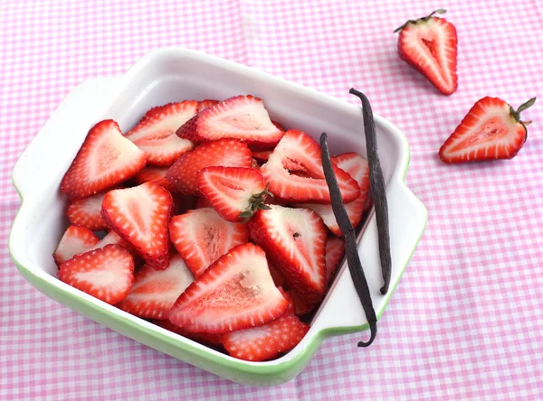 Tranches de fraises dans un bol avec gousse de vanille — Photo