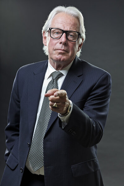 Senior business man wearing dark blue suit and tie with vintage glasses.