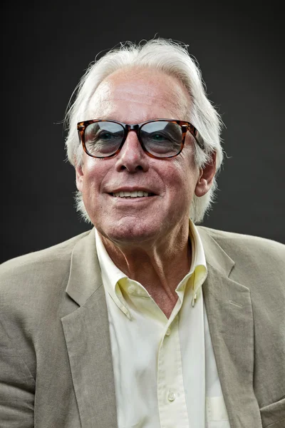 Senior man wearing retro sunglasses and light suit. — Stock Photo, Image