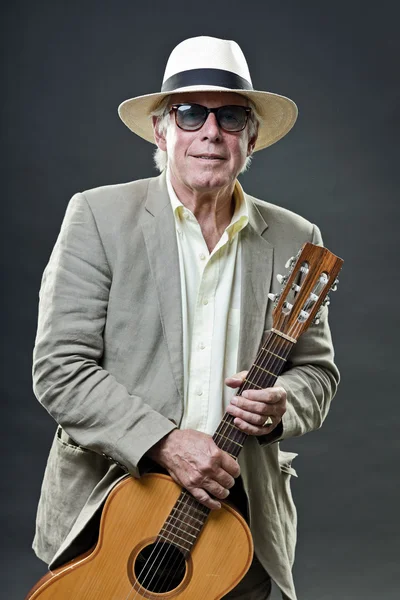 Senior man with accoustic guitar wearing suit hat and sunglasses. — Stock Photo, Image