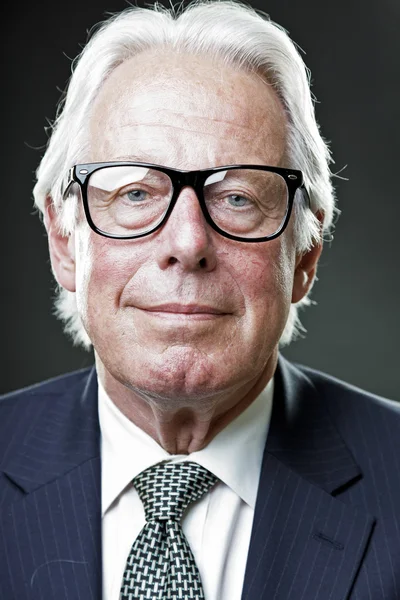 Senior-Geschäftsmann mit Vintage-Brille in dunkelblauem Anzug und Krawatte — Stockfoto