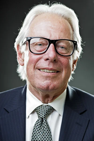 Senior business man with vintage glasses wearing dark blue suit and tie — Zdjęcie stockowe