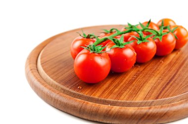 Tomatoes sheri on the wood cutting board clipart