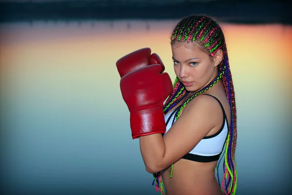 Stock image Portrait of a girl with red boxing gloves