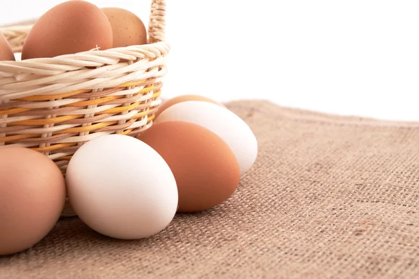 stock image Eggs in basket on a sacking background