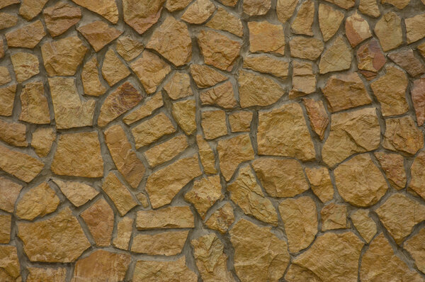 A wall made ​​of natural, large stone. Covering 