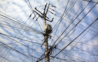 Chaotic tangle of wires on transmission pole clipart