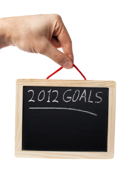 stock image 2012 goals on blackboard held by hand over white background