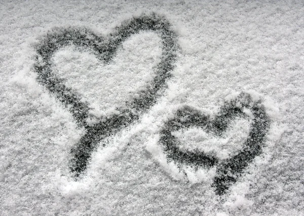 Zwei Herzen auf schneebedecktem Fenster — Stockfoto