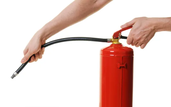 Manos sosteniendo extintor de incendios Imagen De Stock
