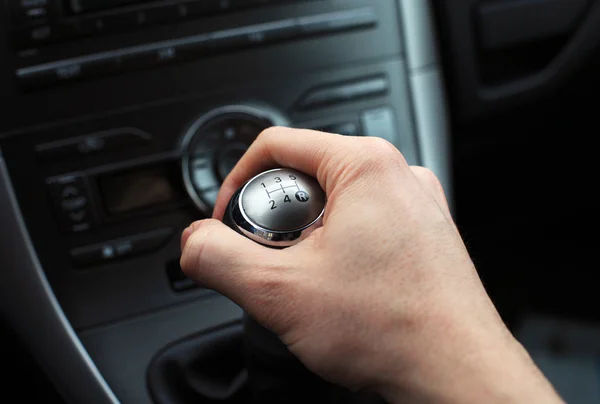 Hand on manual gear shift knob Stock Photo